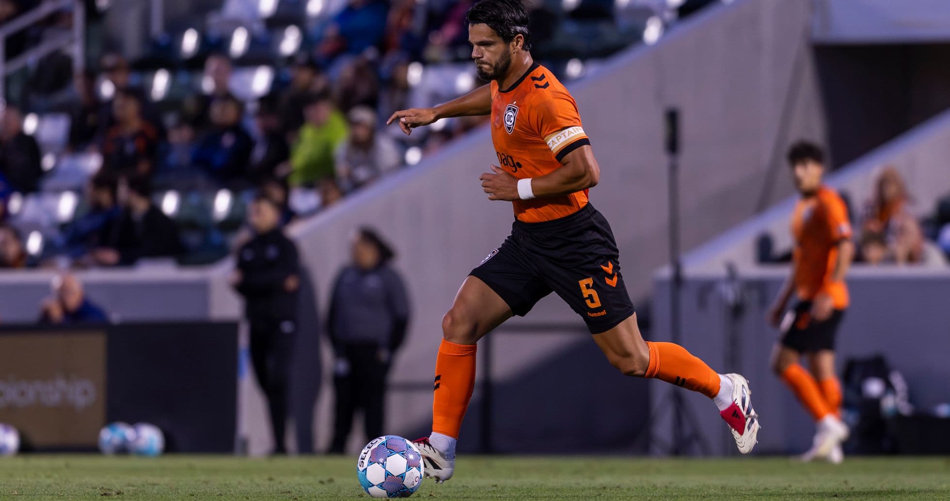 Jugador de Orange County SC corriendo con el balón
