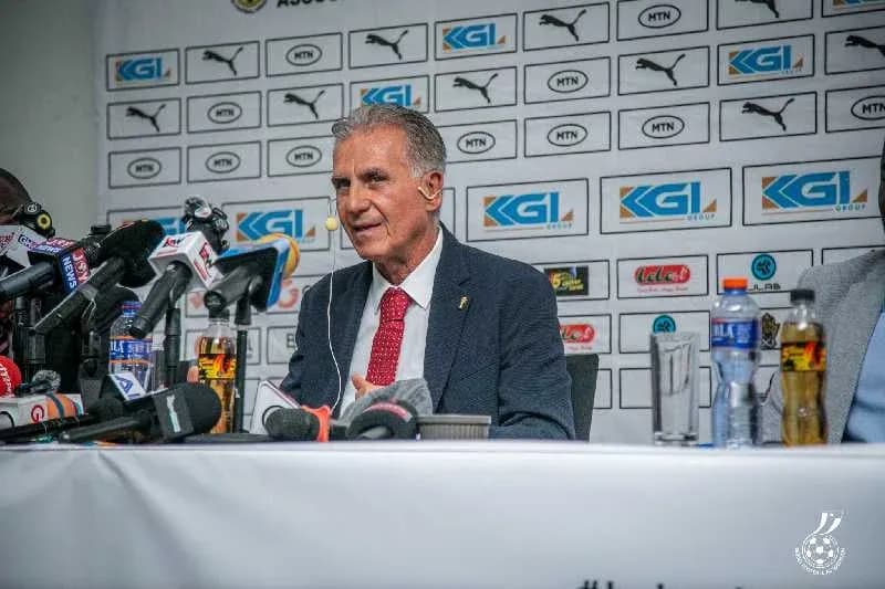 Entrenador en conferencia de prensa con micrófonos