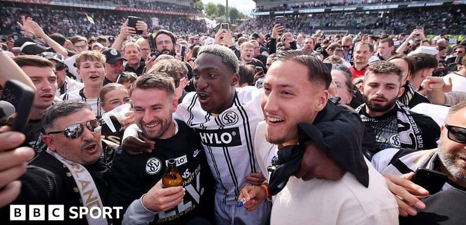 Agroup celebrating with players after a match