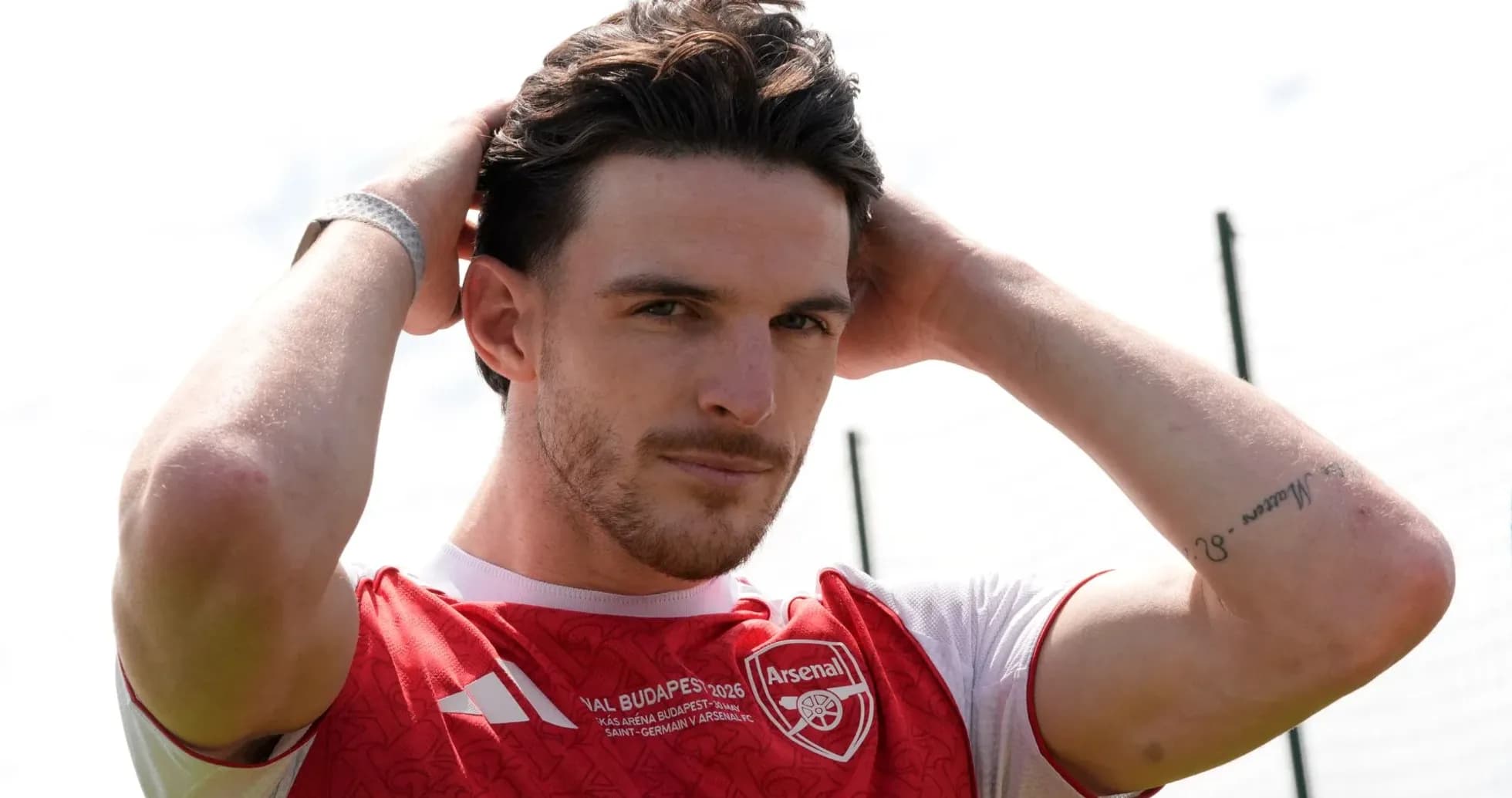 Jugador de Arsenal ajustando su peinado en el campo