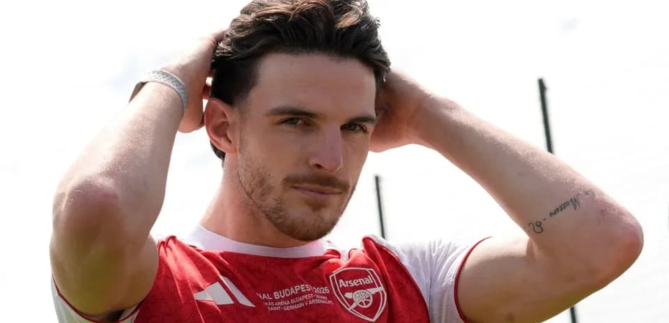 Jugador de Arsenal ajustando su peinado en el campo
