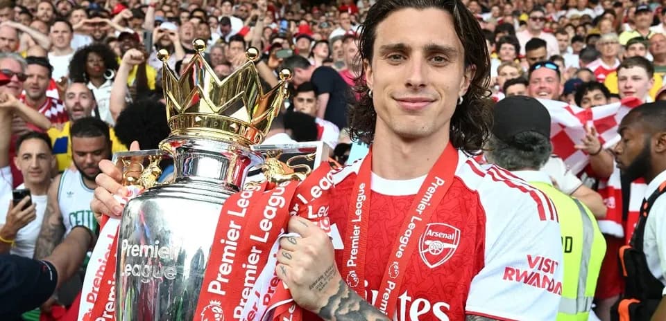 Jugador de Arsenal celebrando con trofeo de Premier League