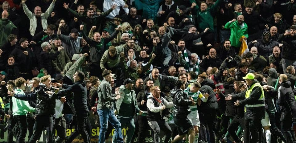 A crowd of fans celebrating a goal at a match