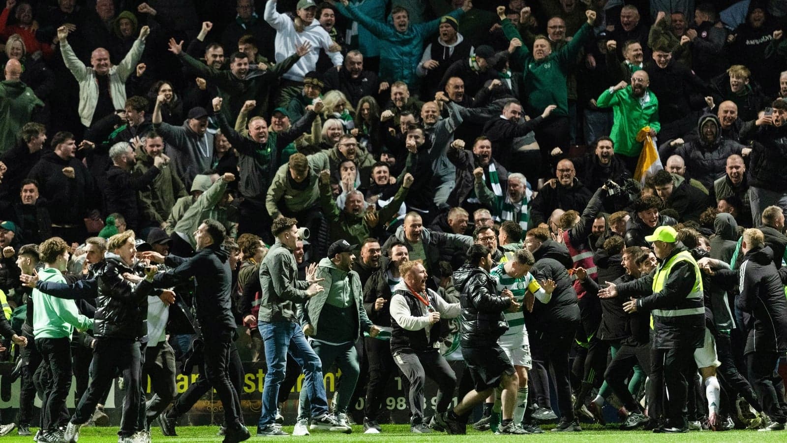 A crowd of fans celebrating a goal at a match