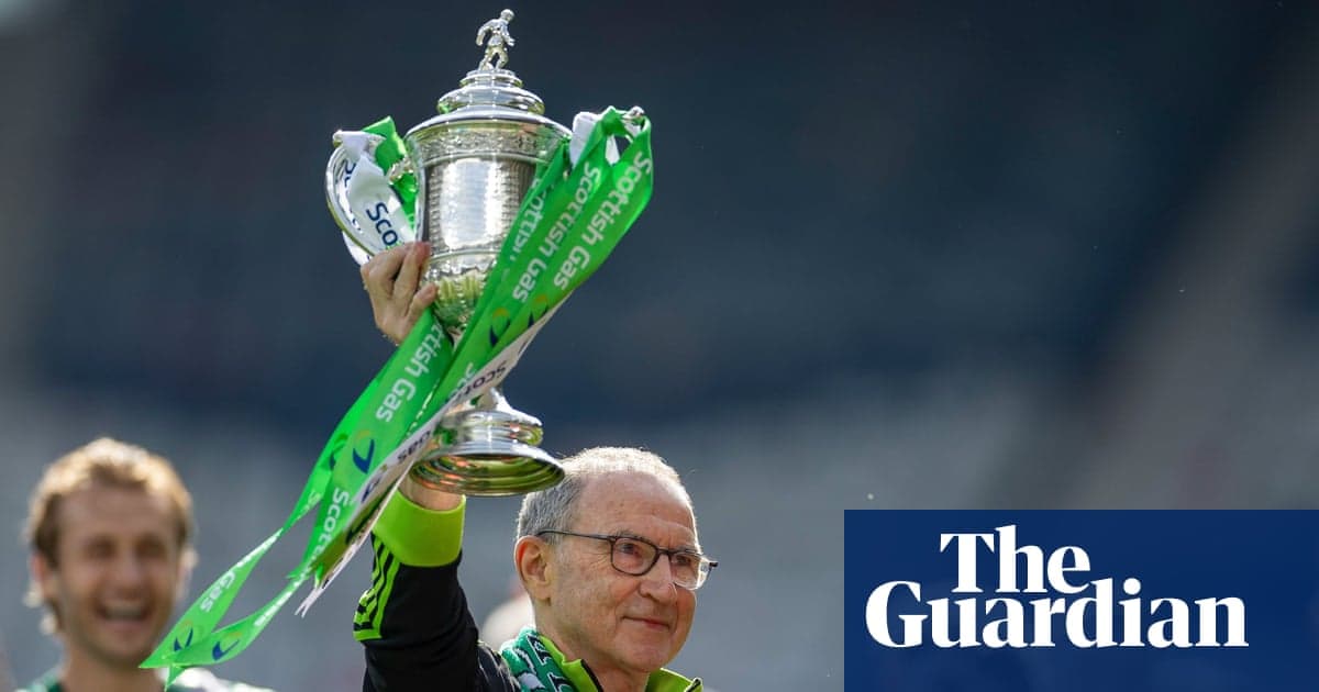 Entrenador levantando el trofeo con cintas verdes
