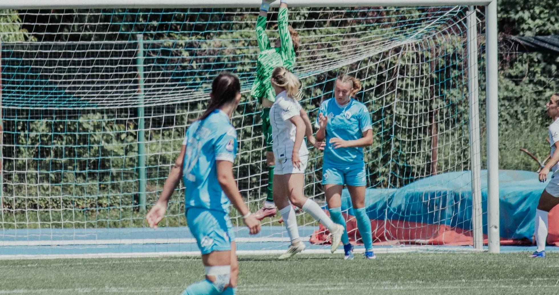 Portera atrapando el balón en un partido