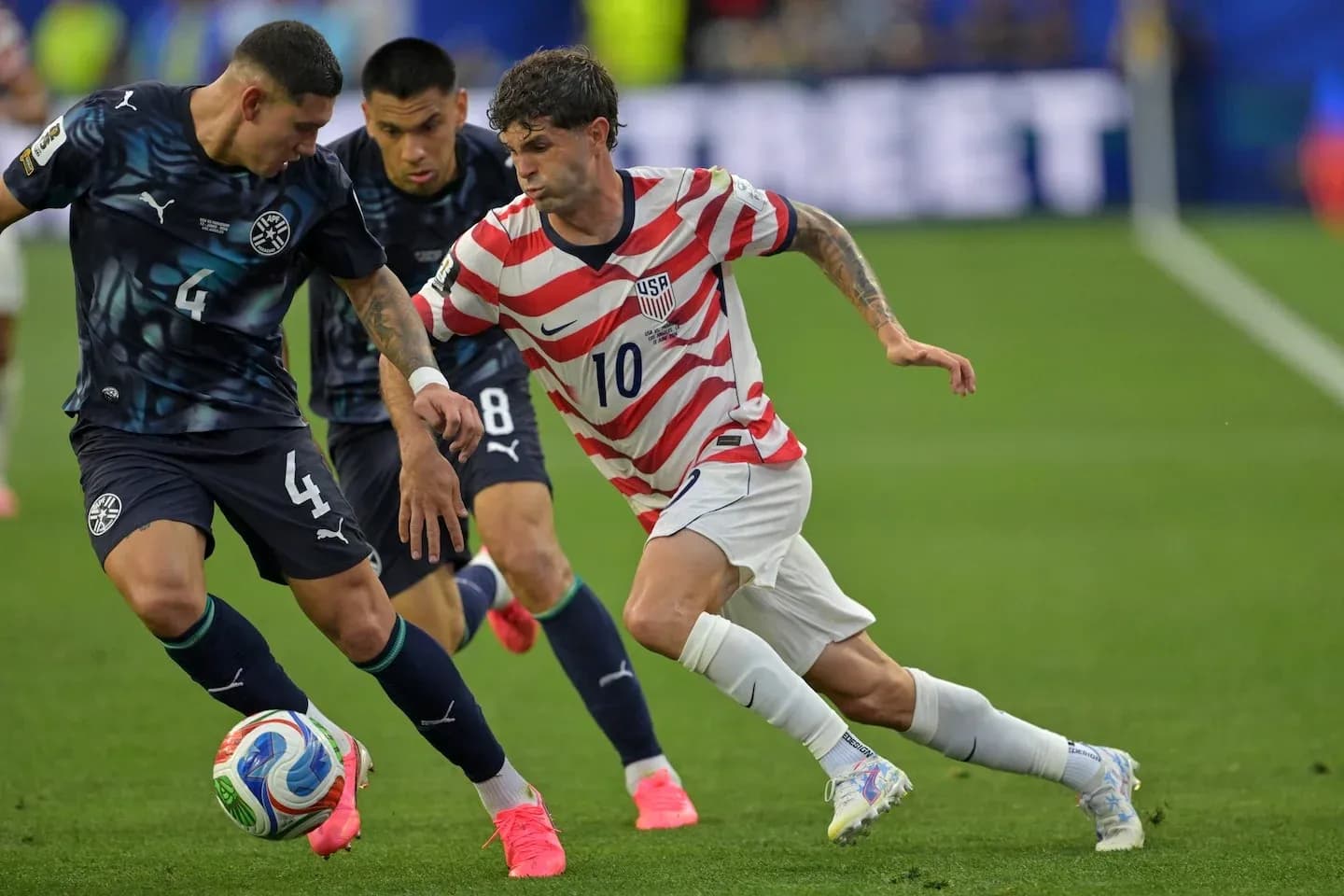 Cristian Pulisic dribbling past defenders during match Cristian Pulisic dribbling past defenders during match